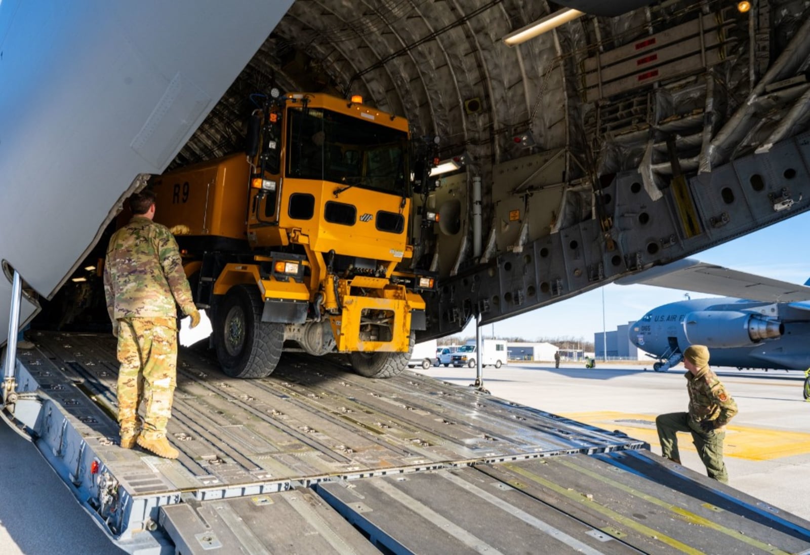 Crews load a snow broom onto a 445th Airlift Wing C-17 for transport to Joint Base Andrews in the Washington, D.C. area. Photo by Christopher Warner, 88th Air Base Wing.
