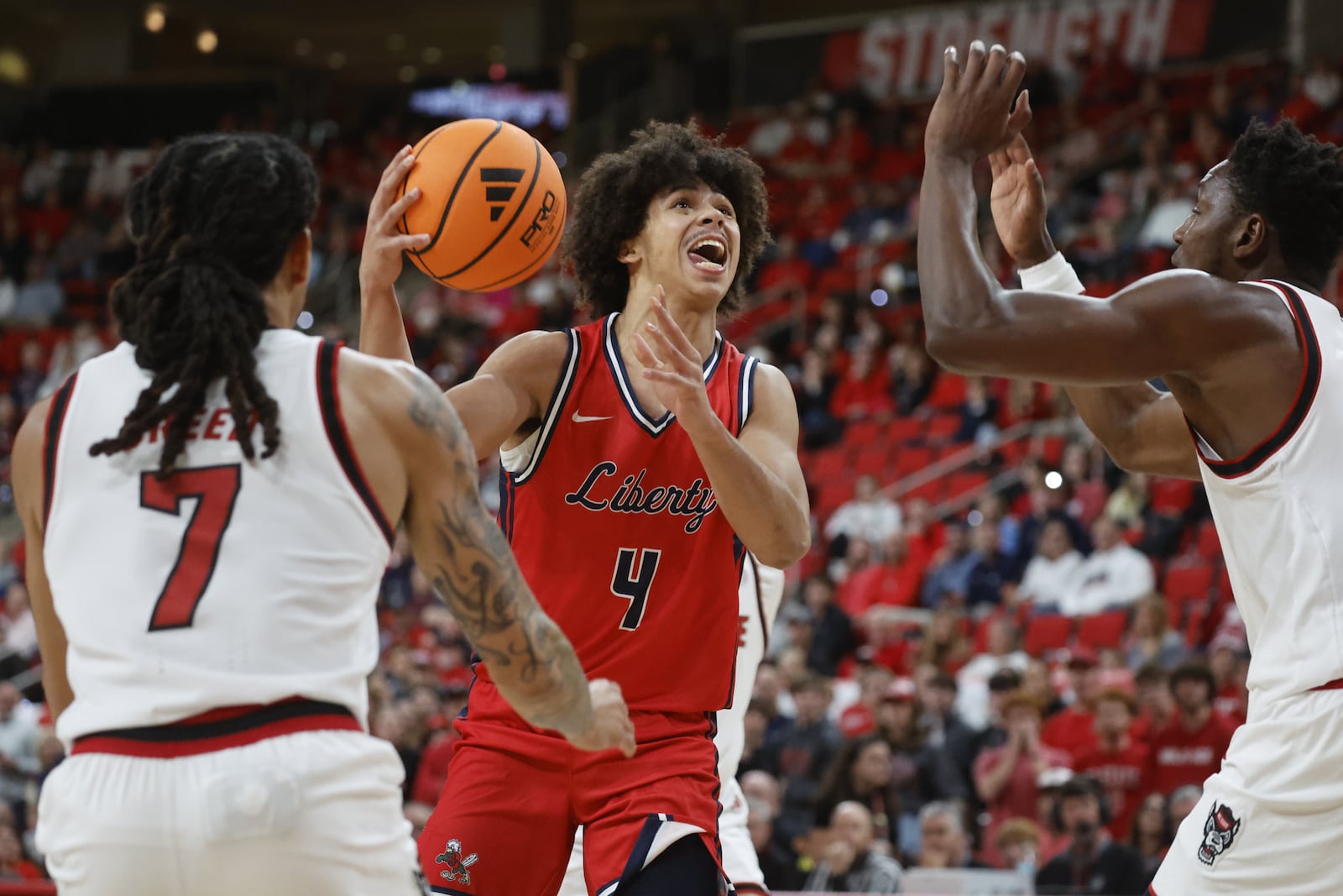 Liberty's Brett Decker Jr. (4) controls the ball against North Carolina State during the first half of an NCAA college basketball game in Raleigh, N.C., Wednesday, Dec. 10, 2025. (AP Photo/Karl DeBlaker)