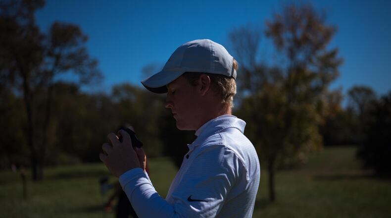 Wright State's Tyler Goecke checks his yardage on a rangefinder during the Dayton Flyer Invitational in October. Goecke, a Carroll High School grad, has won three individual events this season for the Raiders. Joe Craven/Wright State Athletics