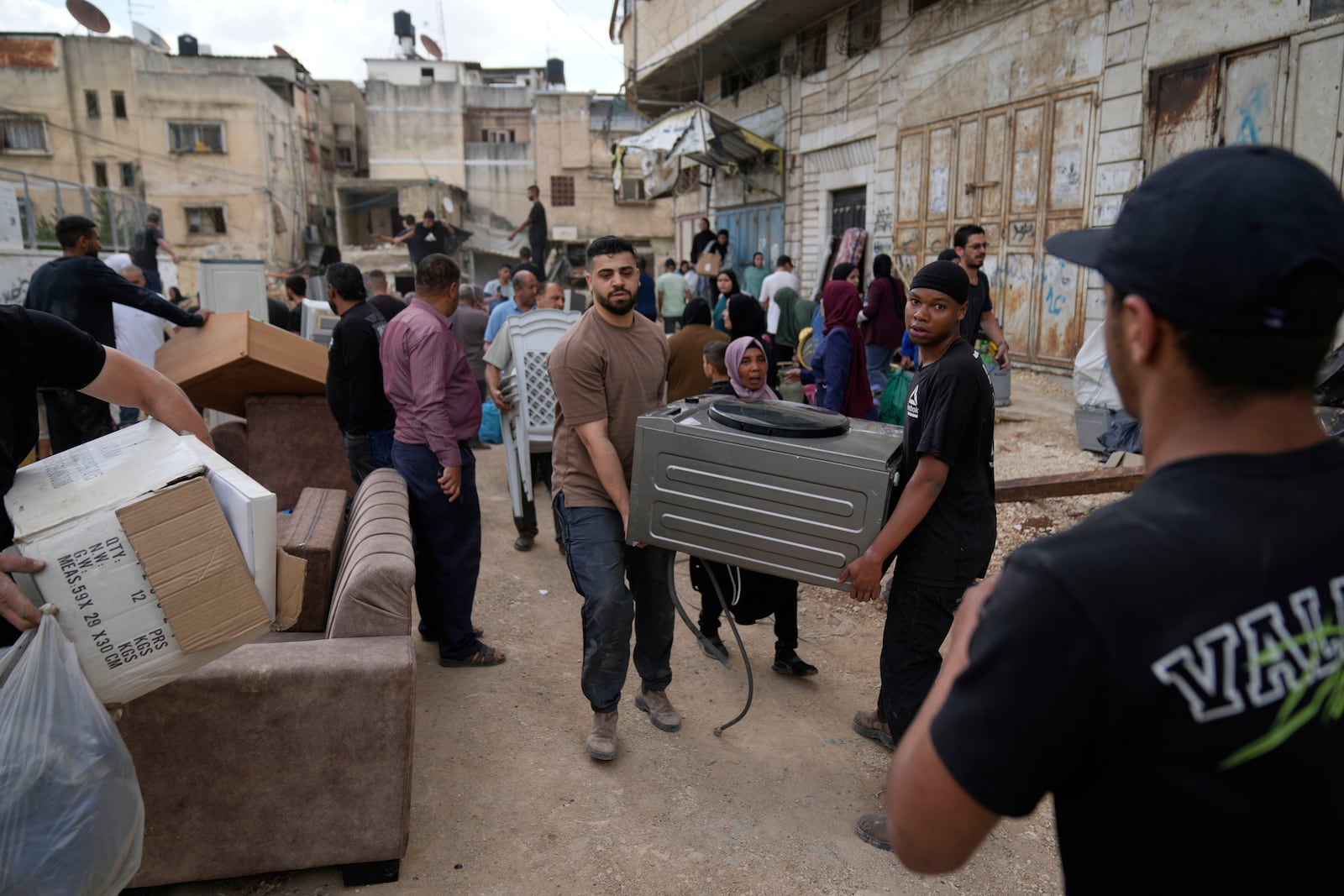 Residents of the now evacuated refugee camp of Tulkarem return to collect belongings before the destruction of their homes as Israeli forces prepare to carry out the demolition of 116 homes across the two refugee camps of the Israeli occupied West Bank city of Tulkarem, Friday, May 2, 2025. (AP Photo/Nasser Nasser)