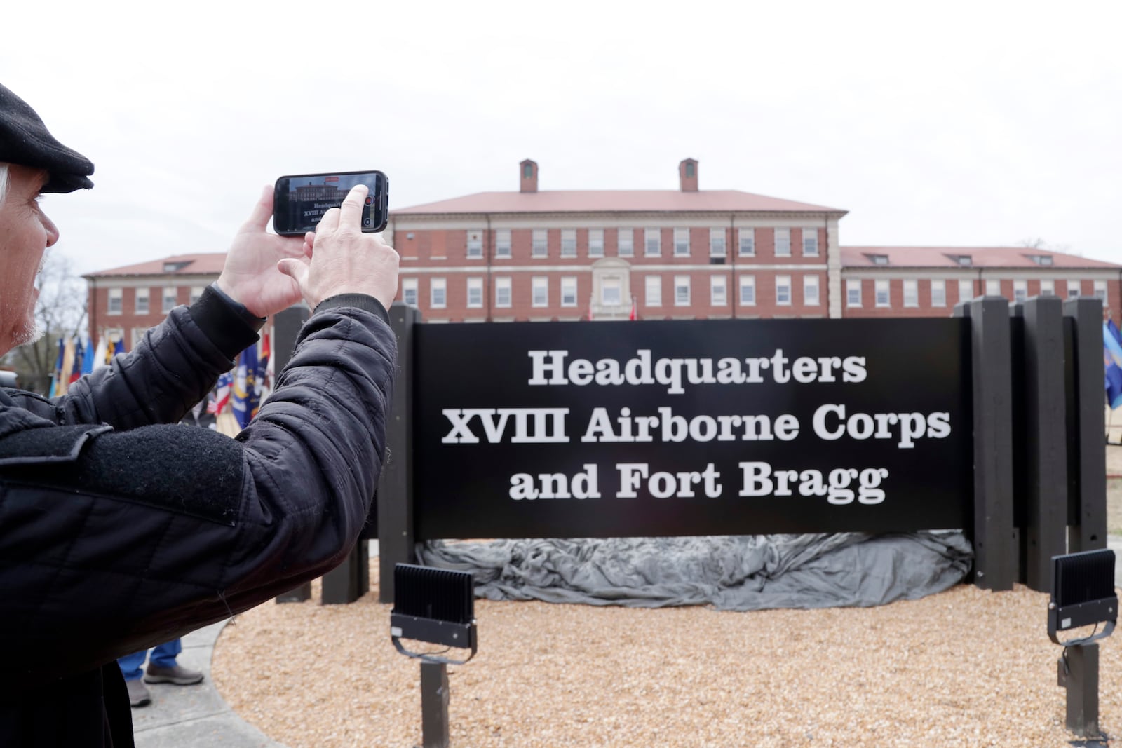 FILE - An attendee takes a photo of the sign that was unveiled when Fort Liberty was rededicated as Fort Bragg during a ceremony on base in North Carolina, March 7, 2025, (AP Photo/Chris Seward, File)