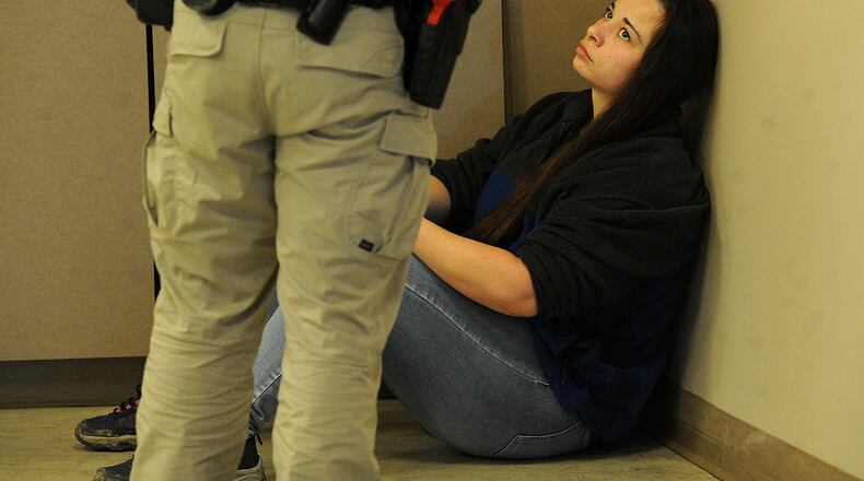 Deputy Keri Benoit of the Butler County Sheriffs Office is an actor for the Sinclair Police Academy's crisis intervention practicals, helping cadets learn how to talk down people in mental health crisis. MARSHALL GORBY/STAFF