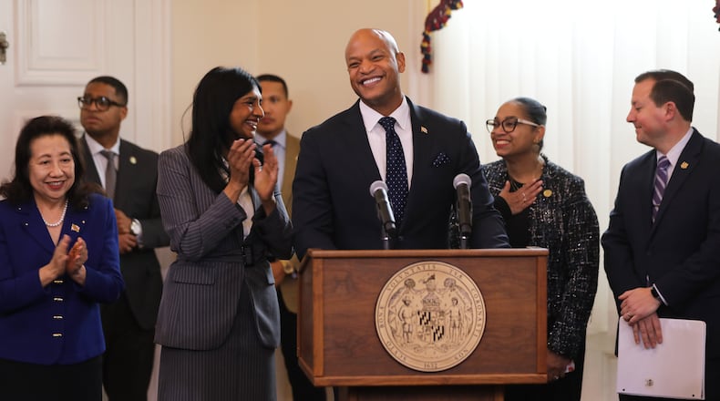 Maryland Gov. Wes Moore, center, smiles before signing legislation that prohibits immigration enforcement agreements with the federal government during a bill-signing ceremony Tuesday, Feb. 17, 2026, in Annapolis, Md. He is joined, from left, by Maryland Secretary of State Susan Lee, Lt. Gov. Aruna Miller, House Speaker Peña-Melnyk and Senate President Bill Ferguson. (AP Photo/Brian Witte)