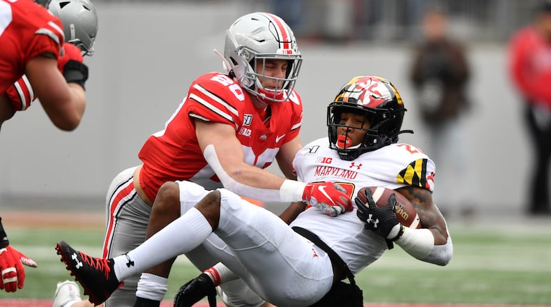 COLUMBUS, OH - NOVEMBER 9:  Pete Werner #20 of the Ohio State Buckeyes tackles Javon Leake #20 of the Maryland Terrapins after a short gain in the second quarter at Ohio Stadium on November 9, 2019 in Columbus, Ohio.  (Photo by Jamie Sabau/Getty Images)