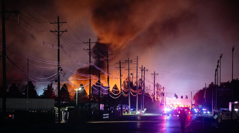 Plumes of smoke rise from the area of a UPS cargo plane crash at Louisville Muhammad Ali International Airport, on Tuesday, Nov. 4, 2025, in Louisville, Ky. (AP Photo/Jon Cherry)