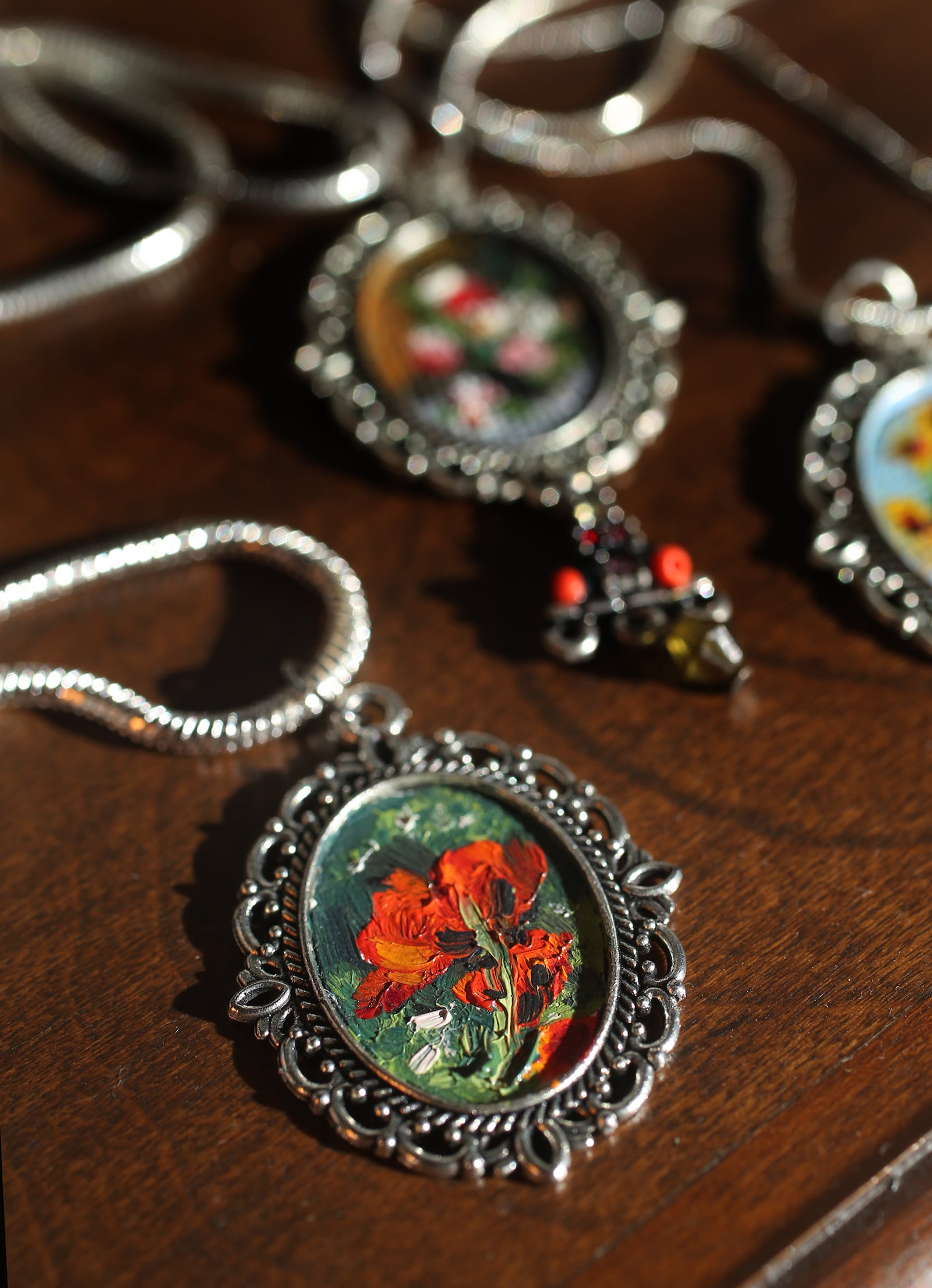 Cecilia Brendel's mini masterpieces, which come in one and two-inch ovals framed in a pendant, are painted with archival oil paints that will last for centuries on Belgian oil primed linen. LISA POWELL / STAFF