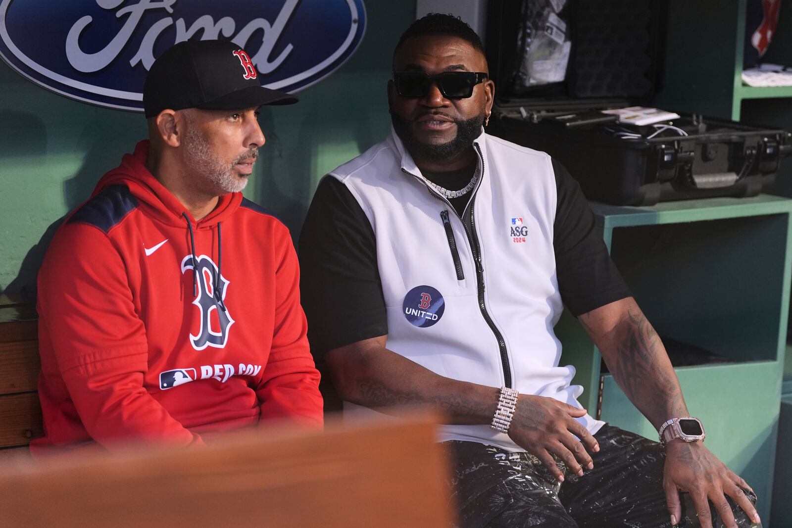 Baseball Hall of Famer David Ortiz, right, talks with Boston Red Sox manager Alex Cora prior to a baseball game against the Tampa Bay Rays at Fenway Park, Tuesday, June 10, 2025, in Boston. (AP Photo/Charles Krupa)
