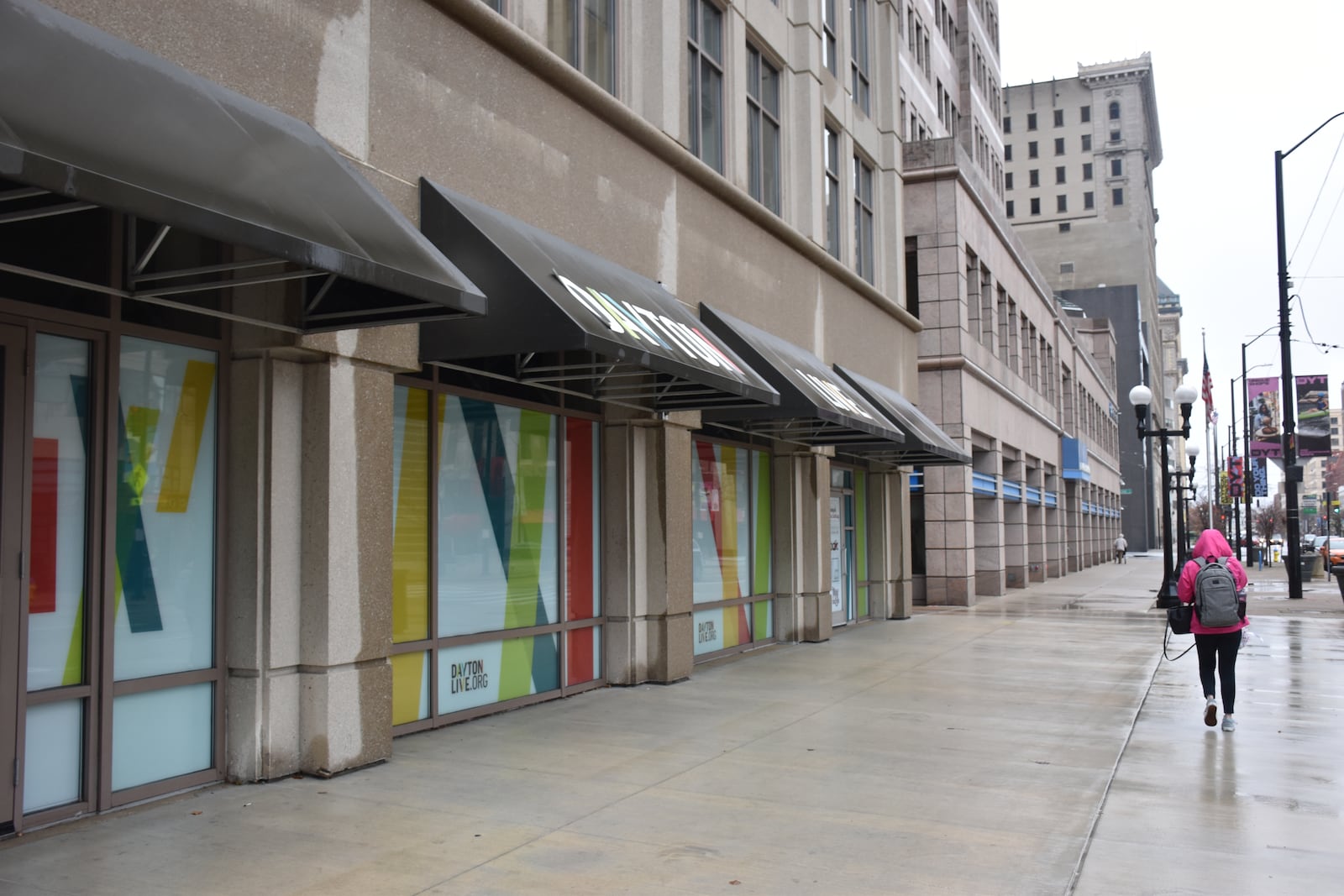 A woman walks by the former Uno Chicago Bar & Grill at 126 N. Main St. in downtown Dayton that closed in 2024. The vacant space was used as a break area for law enforcement during the NATO Parliamentary Assembly that was in Dayton on Memorial Day weekend. CORNELIUS FROLIK / STAFF