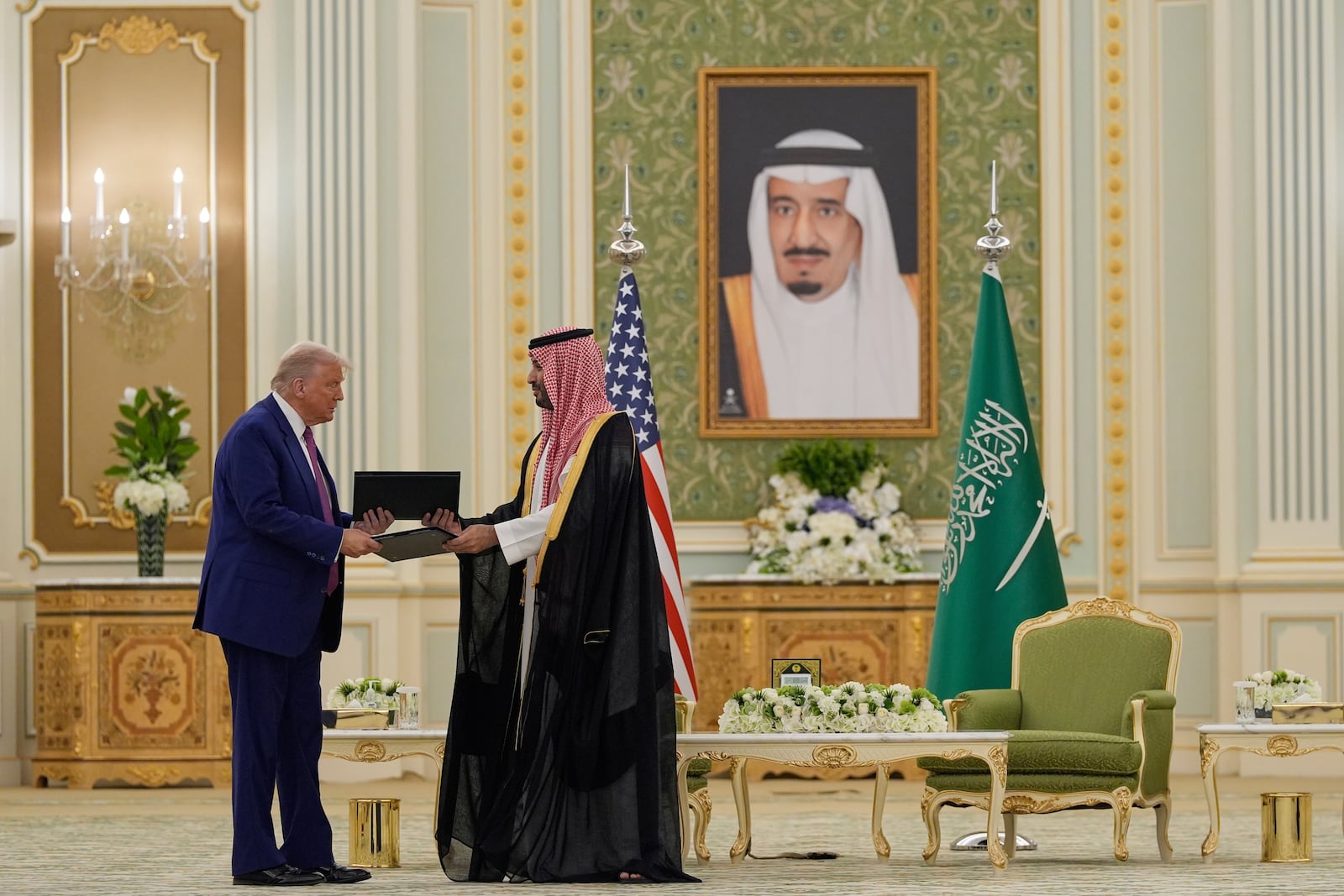 President Donald Trump and Saudi Crown Prince Mohammed bin Salman exchange documents during a signing ceremony at the Royal Palace, Tuesday, May 13, 2025. (AP Photo/Alex Brandon)