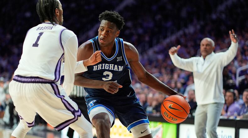 BYU forward AJ Dybantsa (3) looks to get past Kansas State guard Abdi Bashir Jr. (1) during the first half of an NCAA college basketball game Saturday, Jan. 3, 2026, in Manhattan, Kan. (AP Photo/Charlie Riedel)