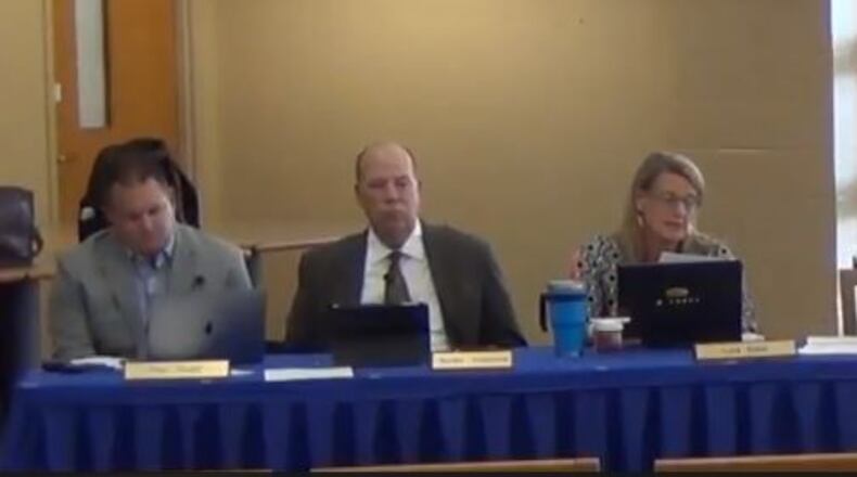 The Springboro school board listens as member Lisa Babb reads a statement at last week’s board meeting.