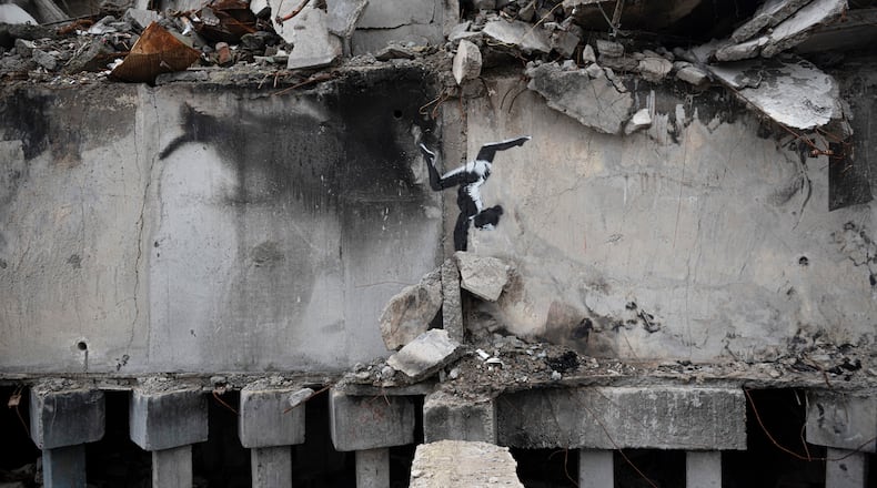 FILE - A painting by British street artist Banksy is seen on a building destroyed by fighting in Borodyanka, Kyiv region, Ukraine, Sunday, Nov. 13, 2022. (AP Photo/Andrew Kravchenko, File)