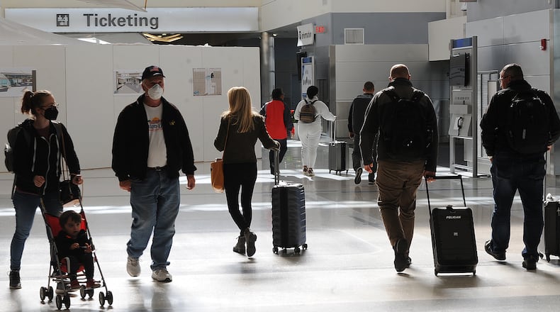 Travelers were making their way through the Dayton International Airport Thursday, Oct. 20, 2022. Prices at area airports have risen over the last year, according to federal data, and experts say that people who plan to travel during the upcoming holidays should buy their tickets as soon as possible. MARSHALL GORBY\STAFF