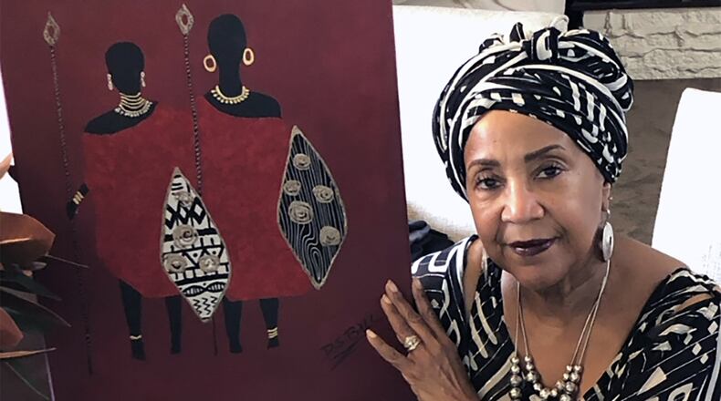 Donna Ball earlier this summer with her artwork entitled "Warrior Women." CONTRIBUTED