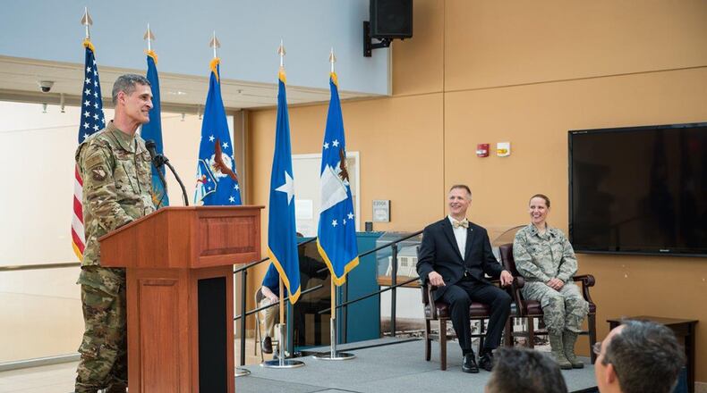 Jack Blackhurst, executive director of the Air Force Research Laboratory, and Brig. Gen. Mark Koeniger, commander of the 711th Human Performance Wing, prepare to cut a ceremonial red ribbon in honor of the activation of the Warfighter Medical Optimization Division, one of five divisions comprising the 711 HPW’s Airman Systems Directorate. The activation ceremony was held May 1 at the United States Air Force School of Aerospace Medicine. (U.S. Air Force photo/Rick Eldridge)