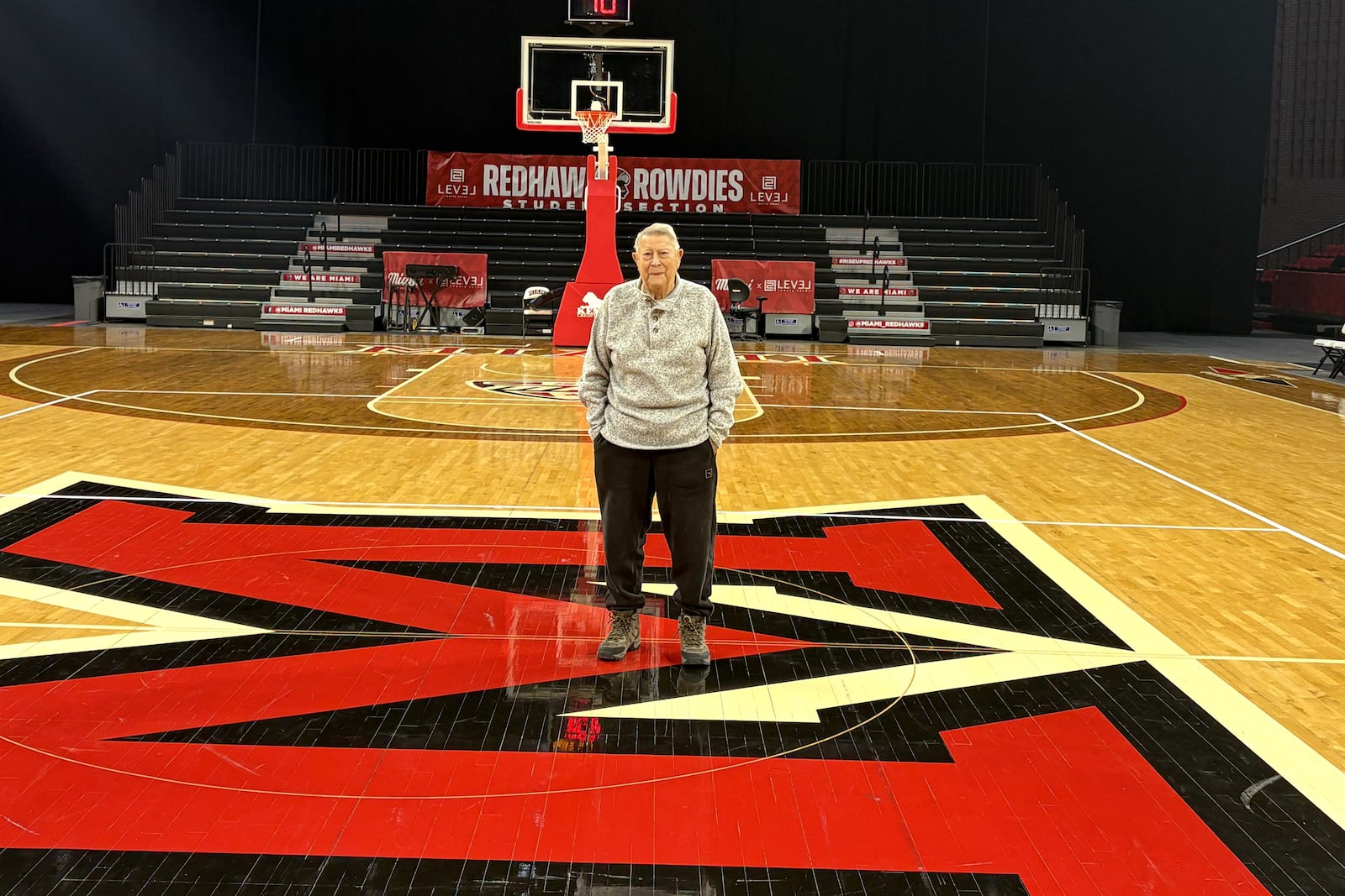Darrell Hedric stands on the court at Millett Hall the other day. He has been involved in Miami’s basketball program for 70 of his 92 years. A star at Franklin High, he came to Miami in 1952, lettered four years in basketball and was the team co-captain. After serving in the Navy, coaching junior high ball in Chillicothe and varsity at Hamilton Taft High, he returned to Miami as an assistant coach, was the head coach for 14 seasons and remains the second winningest coach in program history. He served as associate athletics director, the interim AD and now, at 92, he still keeps regular  office hours at Millett each day and attends every home game, He is considered Miami’s Mr. Basketball. TOM ARCHDEACON / CONTRIBUTED PHOTO