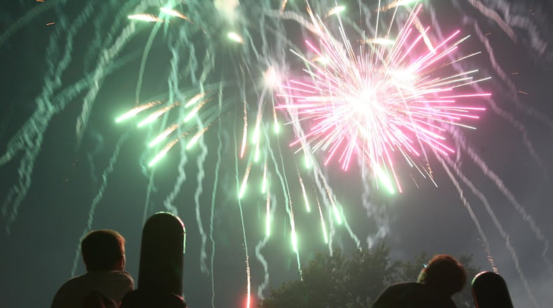 Kids watch from the playground as Rozzi's Famous Fireworks fill the sky at Harbin Park in Fairfield. Rozzi's fireworks will be part of an event Sept. 26, 2020, at Caesar Ford Park in Xenia. GREG LYNCH/FILE