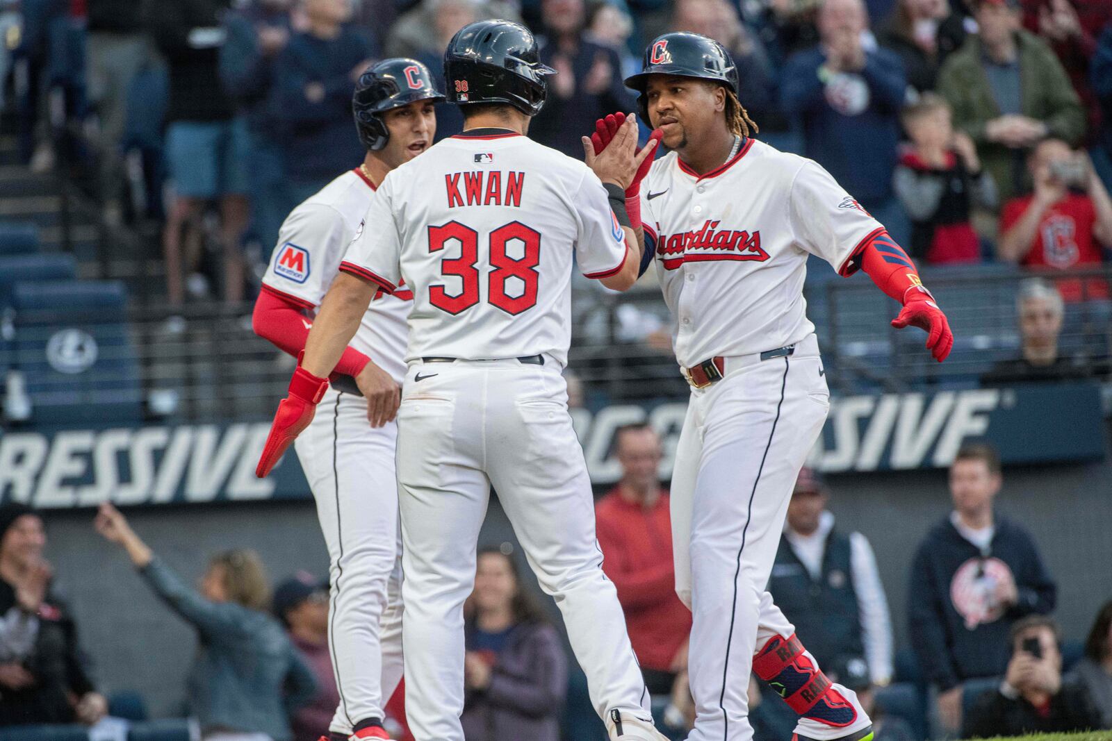 Cleveland Guardians' Steven Kwan (38) and Brayan Rocchio, left rear, congratulate Jose Ramirez, right, after Ramirez's three-run home run off New York Yankees starting pitcher Clarke Schmidt during the third inning of a baseball game in Cleveland, Monday, April 21, 2025. (AP Photo/Phil Long)