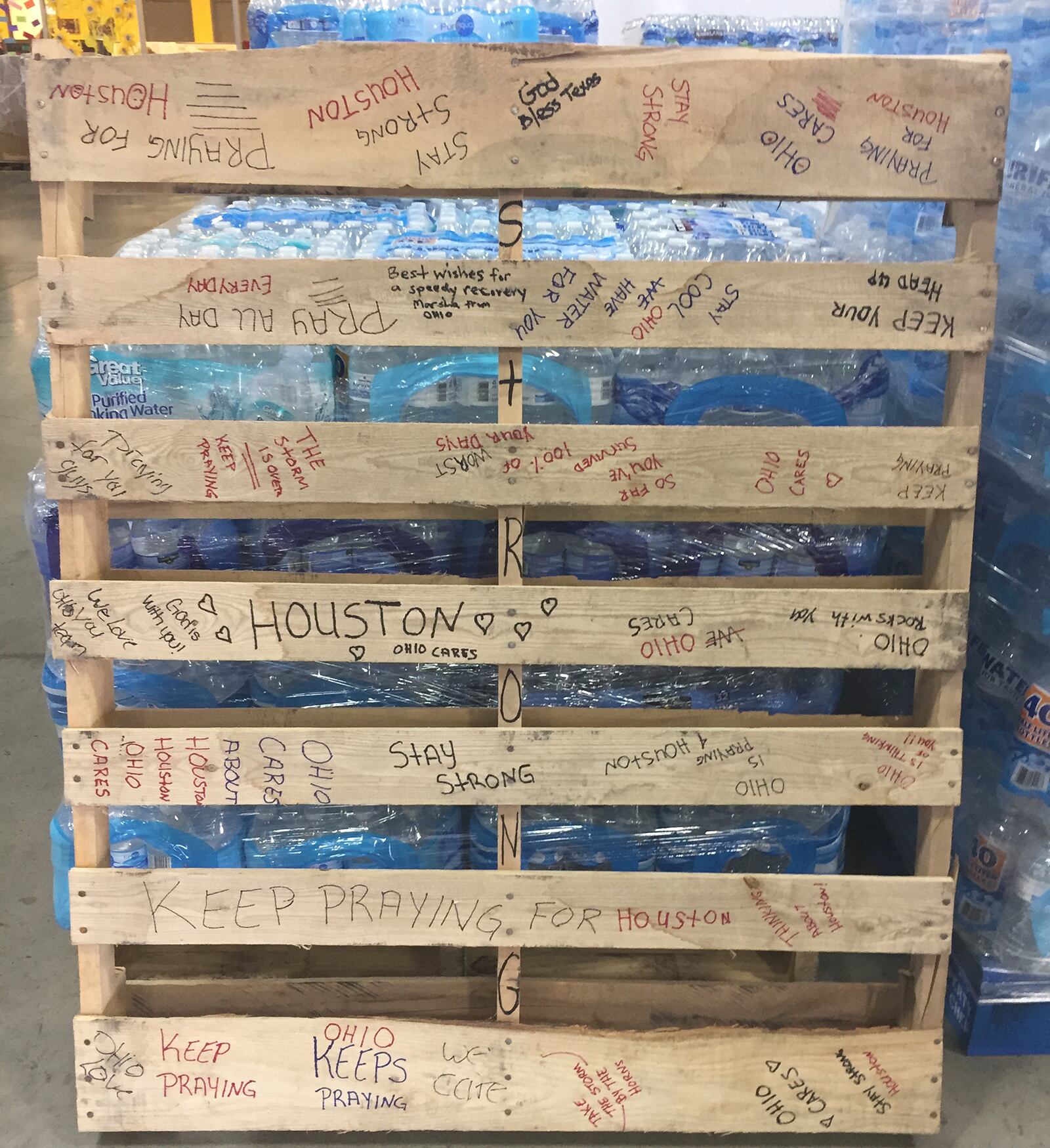 Messages have been left at The Foodbank in Dayton on donated cases of water and pallets bound to victims of Harvey in Texas. SUBMITTED