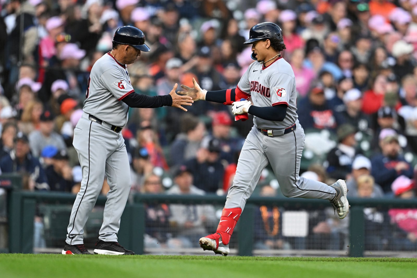 Cleveland Guardians' Bo Naylor, right, celebrates with third base coach Rouglas Odor, left, as he circles the bases after hitting a home run against the Detroit Tigers in the third inning of a baseball game Saturday, May 24, 2025, in Detroit. (AP Photo/Lon Horwedel)