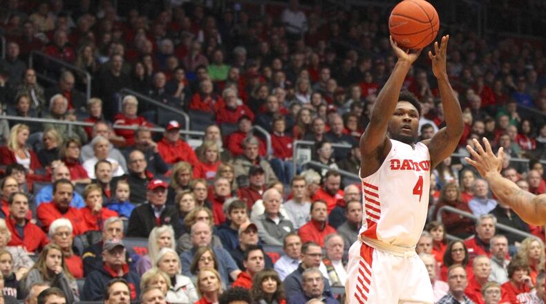 Dayton's Jordan Davis makes a 3-pointer in front of Massachusetts guard Luwane Pipkins on Sunday, Jan. 13, 2019, at UD Arena.