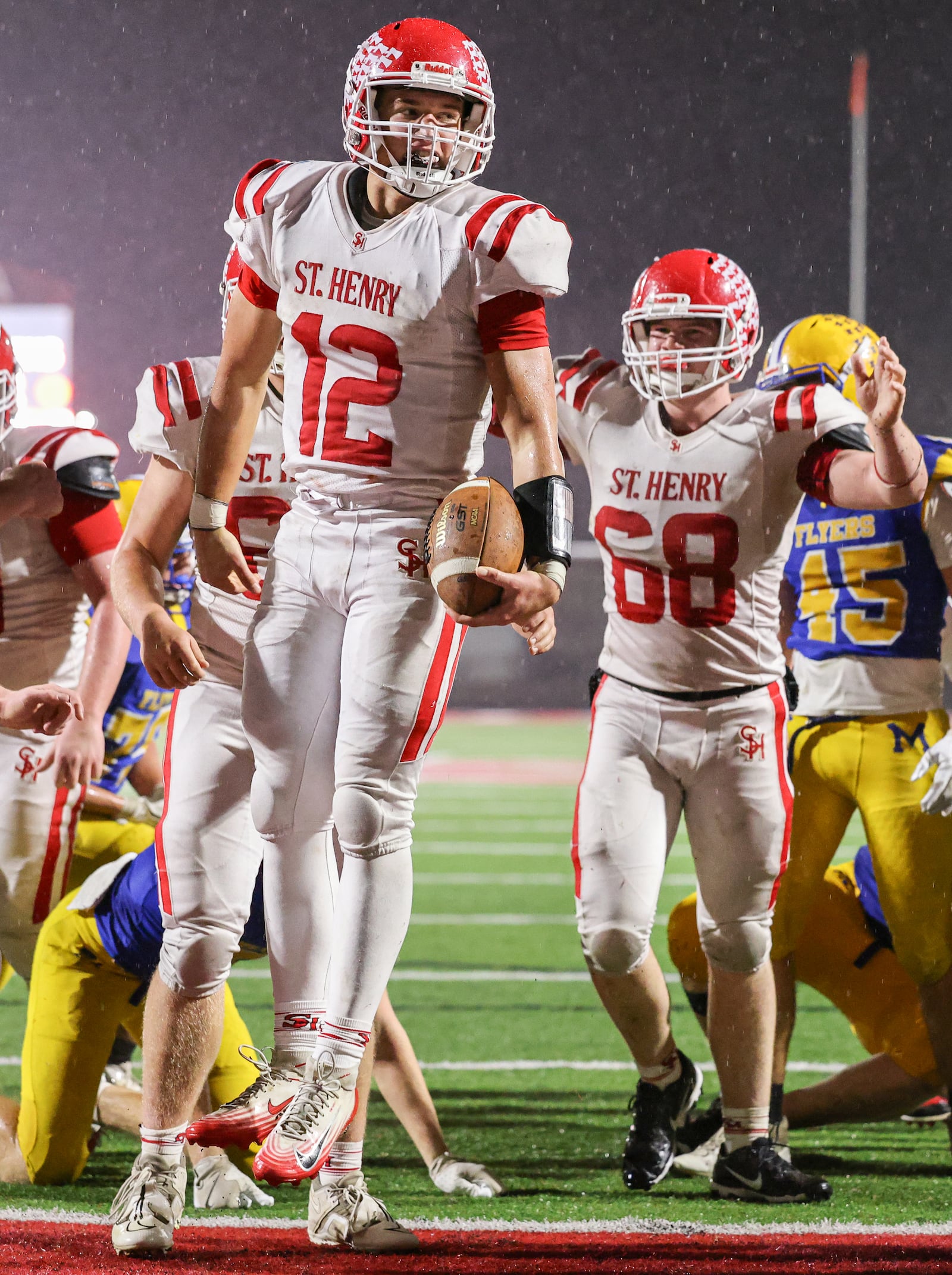 St. Henry senior quarterback Charlie Werling celebrates after a short touchdown run in the third quarter of the Division VII, Region 28 championship game on Friday, Nov. 21 at Mercy Health/Wapak VFW Field in Wapakoneta. Werling scored four TDs to help the Redskins win 24-7 and snap a 76-game winning streak by the Flyers. BRYANT BILLING/STAFF