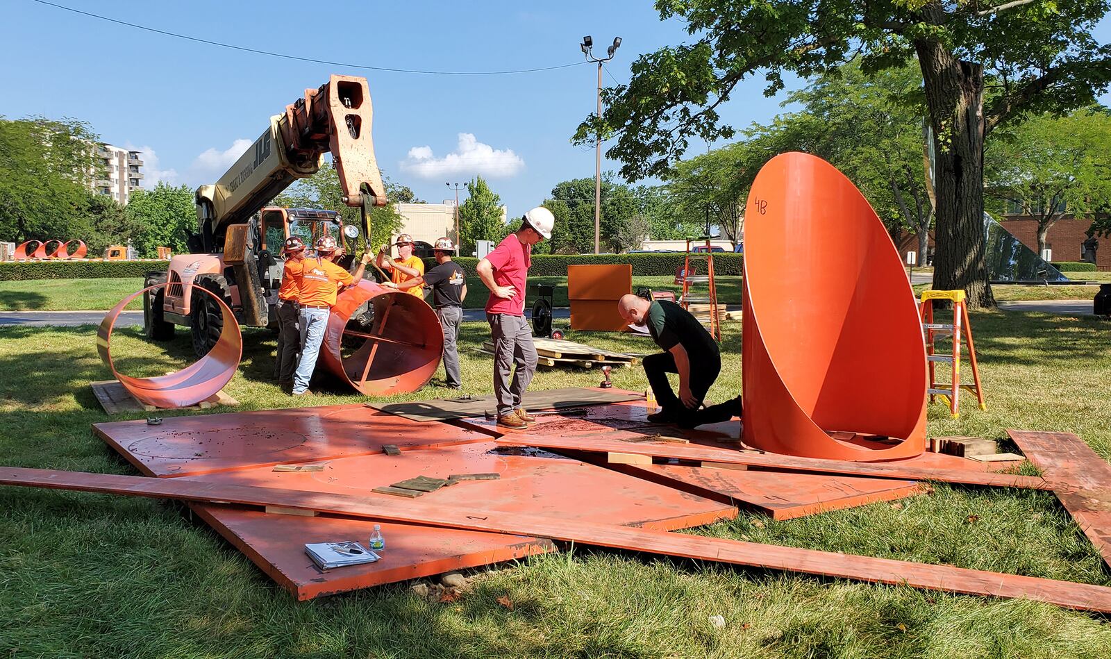 “Firmament,” the bright orange sculpture of steel cylinders on the Dayton Art Institute grounds, was removed Monday, Aug. 23 for conservation work. The artwork, created by Alexander Liberman, has been part of the museum’s collection since 1976. It will be returned in November. ERIC BROCKMAN / DAYTON ART INSTITUTE
