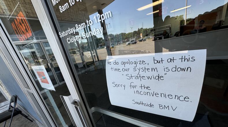 A sign posted to the door at the Ohio BMV site in Springfield Friday morning, July 19, 2024, said the office is closed because its systems are down statewide. BILL LACKEY/STAFF