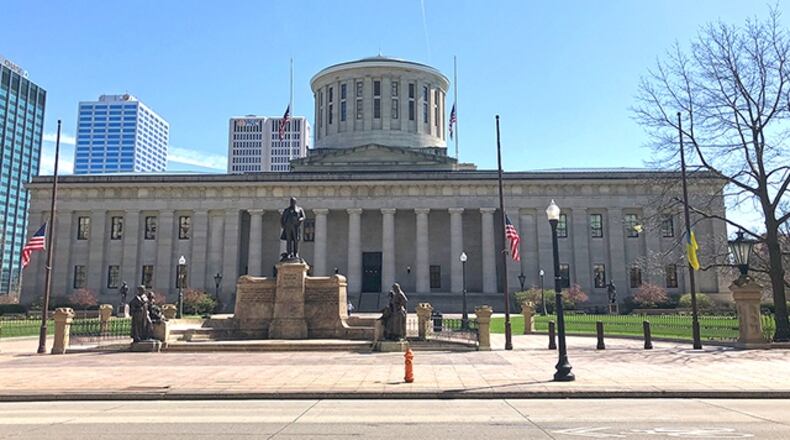 Flags fly at half staff in front of the Ohio Statehouse.