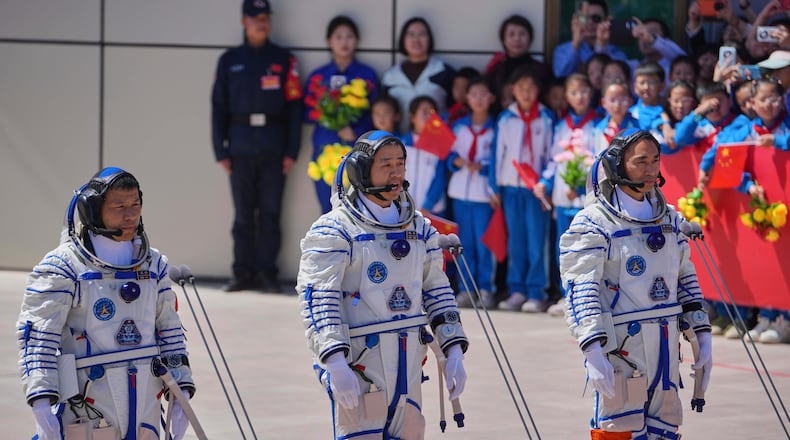 FILE - Chinese astronaut for the Shenzhou 20 mission, Chen Dong, center, speaks next to his comrades Chen Zhongrui, right, and Wang Jie as they attend a send-off ceremony for their manned space mission at the Jiuquan Satellite Launch Center in northwestern China, Thursday, April 24, 2025. (AP Photo/Andy Wong, file)