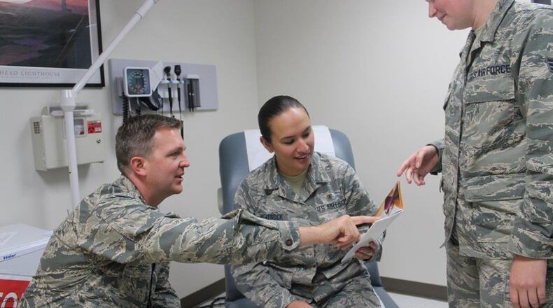 Maj. Justin Fox, 88th Medical Group plastic surgeon, and medical technician Senior Airman Leah Borland, discuss plastic surgery options with Airman 1st Class Brittany Hartsock (middle). The 88th Medical Group plastic surgery clinic’s primary mission is to provide reconstructive procedures but also offers cosmetic procedures. (U.S. Air Force photo/Stacey Geiger)