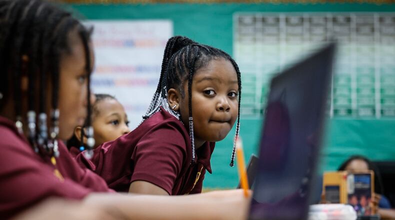 Dayton Leadership Academies second grader Abrielle Wade works on a computer at the school Friday, December 1, 2023.  A rising number of students are enrolled in charter and private schools in Ohio. JIM NOELKER/STAFF