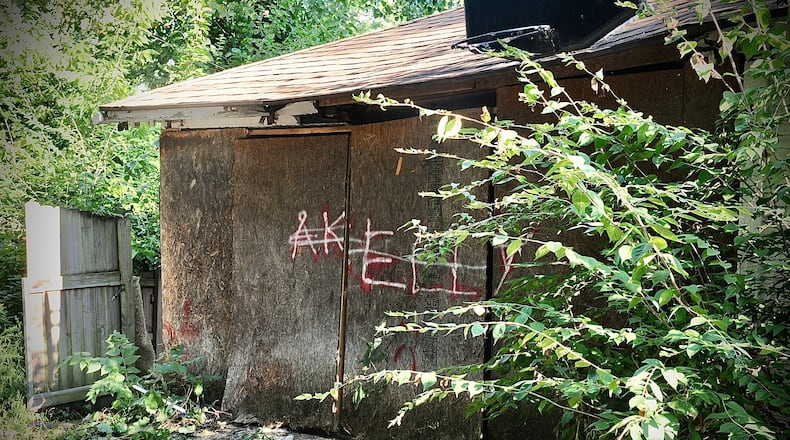 A badly decomposing body found under debris in the detached garage of a Burkhardt Avenue house on Thursday, Aug. 18, 2022, was later identified as 44-year-old CJ Pierce of Dayton, who was reported missing in July. MARSHALL GORBY / STAFF
