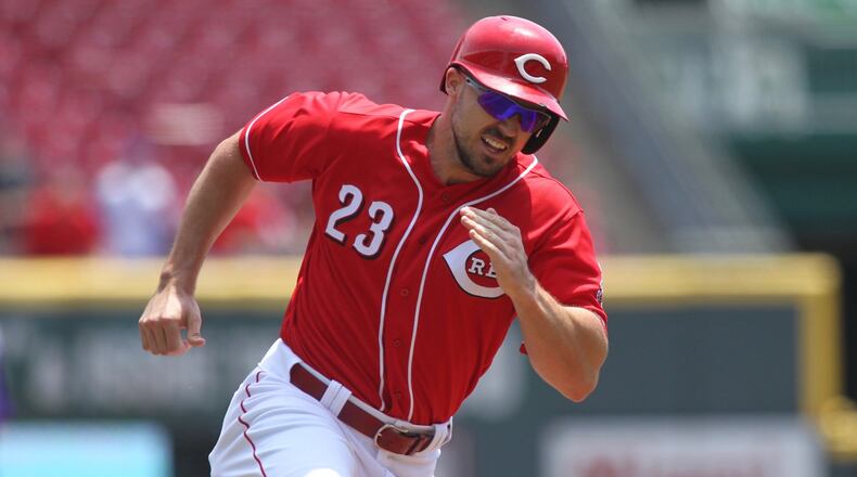 The Reds’ Adam Duvall scores in the second inning against the Rockies on Thursday, June 7, 2018, at Great American Ball Park in Cincinnati. David Jablonski/Staff