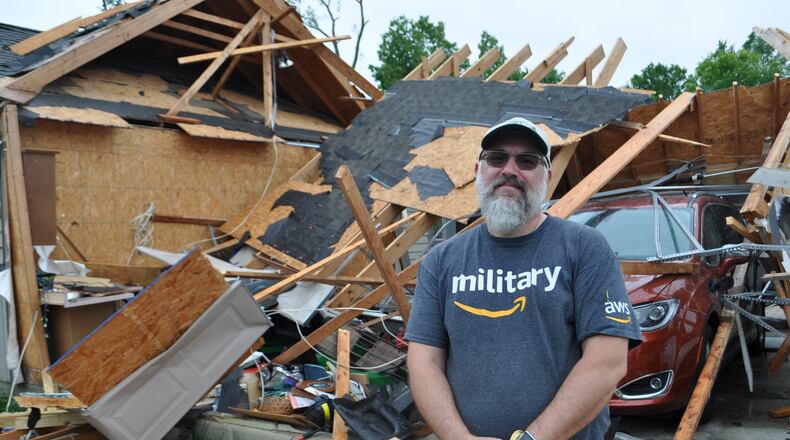 Mike Roberts of Charlie Court in Brookville stands in front of his garage that was destroyed by a tornado late Monday night. An EF 3 tornado tore through Brookville as part of a 13 tornado outbreak on Memorial Day.