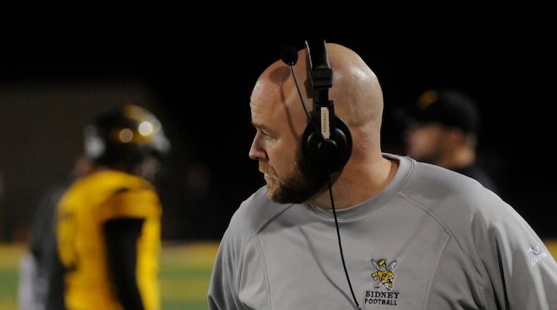 Sidney coach Adam Doenges led the Yellow Jackets to a 46-33 defeat of visiting Belmont in a D-II, Region 8 playoff opener. MARC PENDLETON / STAFF