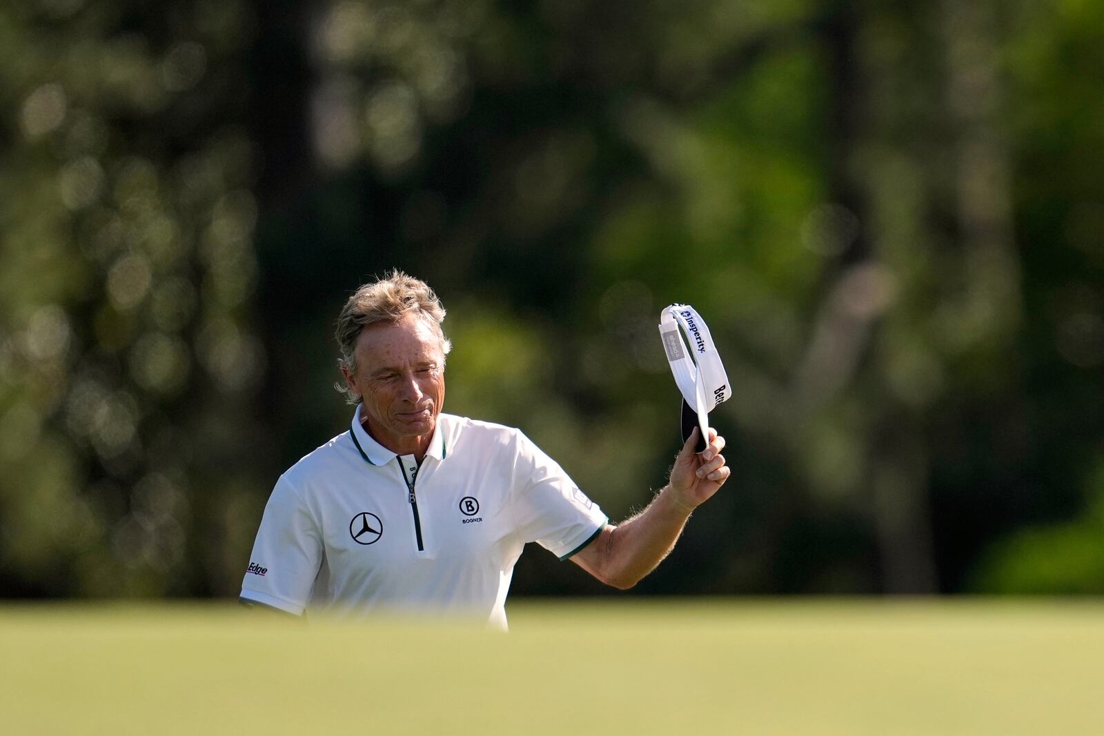 Bernhard Langer, of Germany, waves to the gallery on the 18th green during the second round at the Masters golf tournament, Friday, April 11, 2025, in Augusta, Ga. (AP Photo/George Walker IV)
