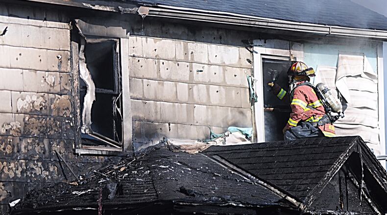 Firefighters respond to a structure fire near Tipp City. Marshall Gorby/STAFF