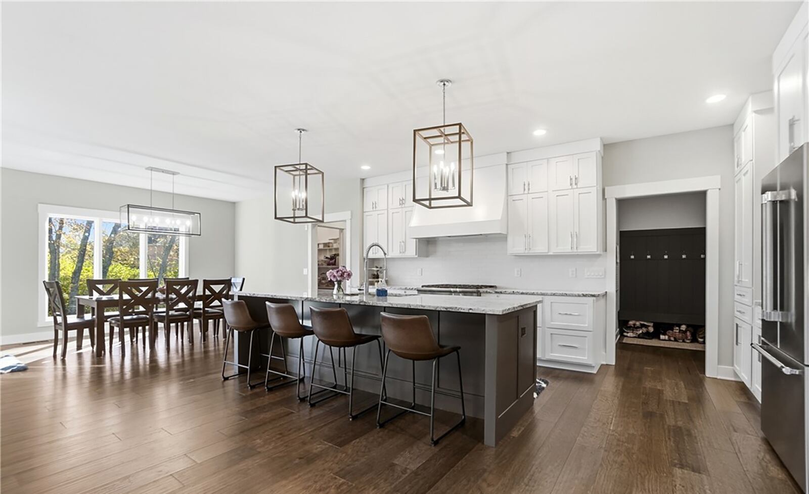 The kitchen has custom built cabinets, hardwood floors, high end stainless appliances and an island with bar seating. CONTRIBUTED