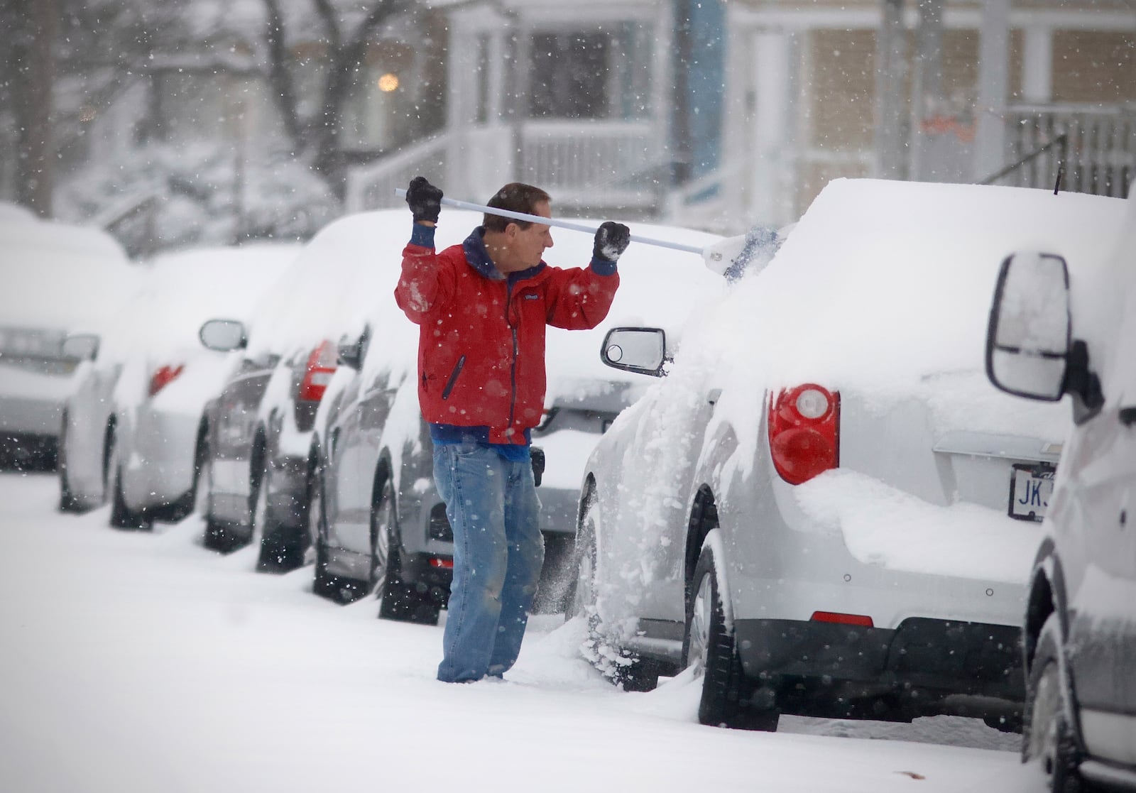 Paul Adams clears the snow from his vehicle on Monday, Jan. 6, 2025 on Stanton Avenue in Springfield after a heavy snowfall overnight. MARSHALL GORBY/STAFF