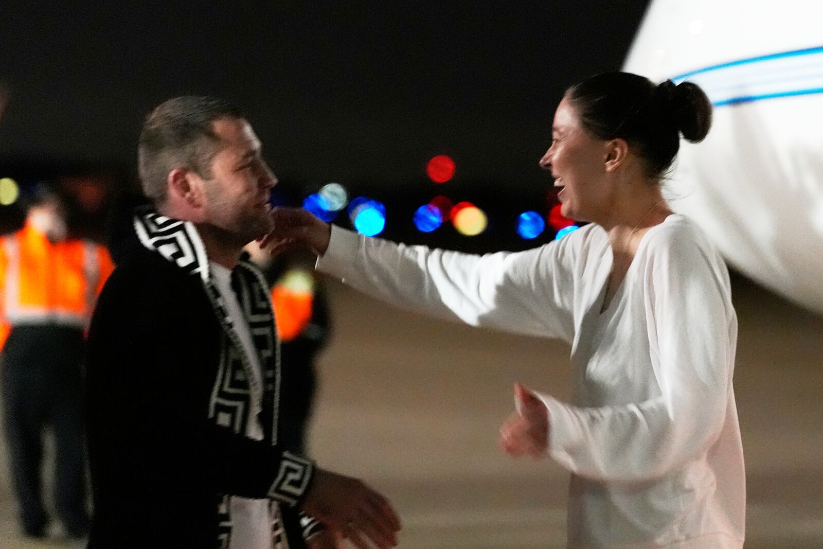 Ksenia Karelina greets her fiancé, professional boxer Chris van Heerden, as she arrives Thursday, April 10, 2025, at Joint Base Andrews, Md. (AP Photo/Alex Brandon)