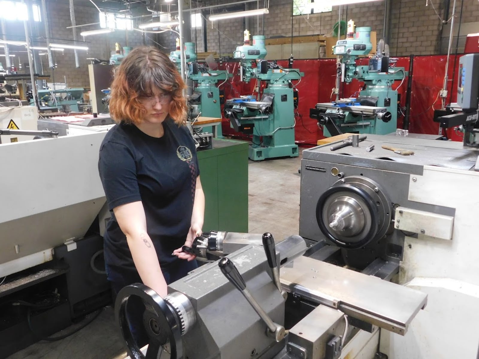 A student at a manufacturing skills sprint session last April at a Sinclair Community College training facility on Eaker Street. She is learning how to operate a manual lathe. CONTRIBUTED.