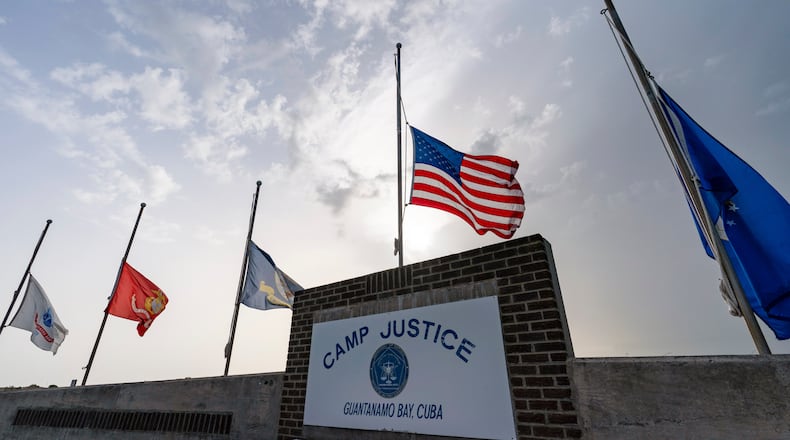 FILE - In this photo reviewed by U.S. military officials, flags fly at half-staff at Camp Justice, Aug. 29, 2021, in Guantanamo Bay Naval Base, Cuba. (AP Photo/Alex Brandon, File)