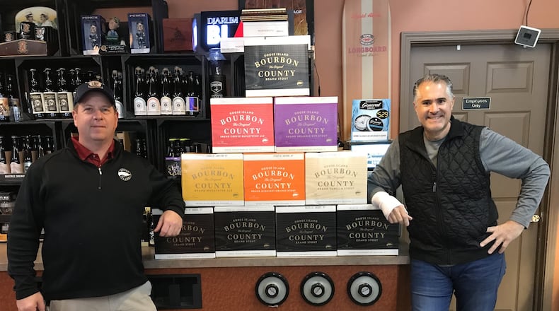 George Karras, right, owner of The Market in Kettering, stands with his shipment of Goose Island Bourbon County Brand Stout at his store.