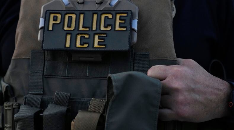 FILE - A U.S. Immigration and Customs Enforcement agent takes part in an early morning operation in Park Ridge, Ill., Sept. 19, 2025. (AP Photo/Erin Hooley, File)