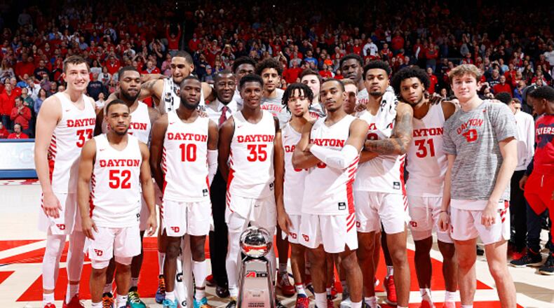 DAYTON, OH - MARCH 07: Dayton Flyers players and coaches celebrate after the game against the George Washington Colonials at UD Arena on March 7, 2020 in Dayton, Ohio. Dayton defeated George Washington 76-51 and won the Atlantic 10 Conference regular season title. (Photo by Joe Robbins/Getty Images)