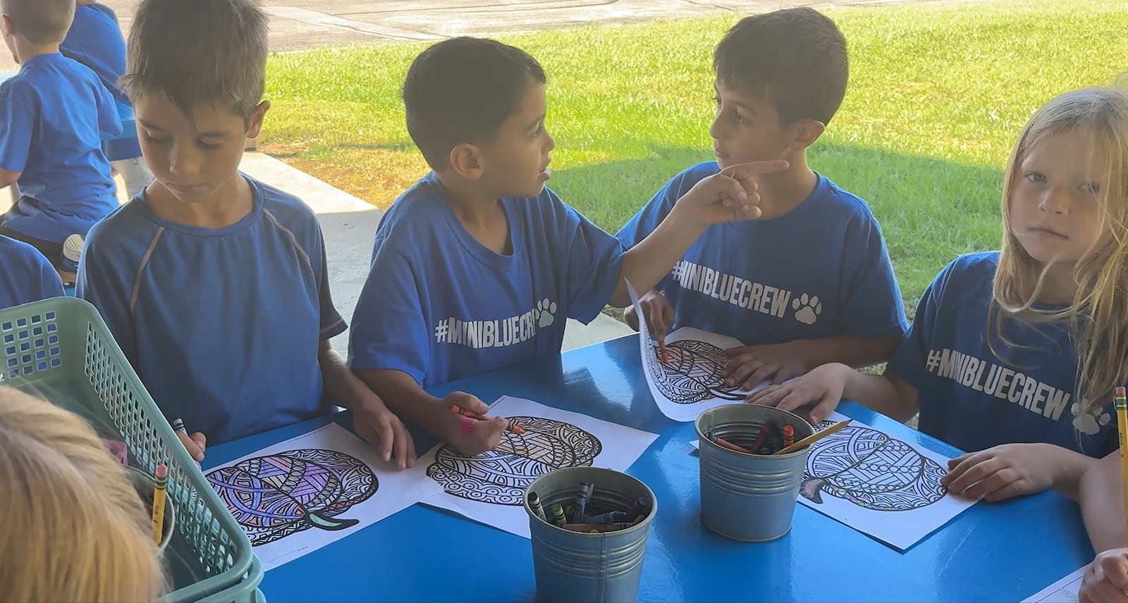 A group of Clearcreek Elementary School students sit at one of the table and chair sets Thursday, Oct. 9, 2025, in the new outdoor classroom in the shelter behind the school in Springboro. JEN BALDUF/STAFF