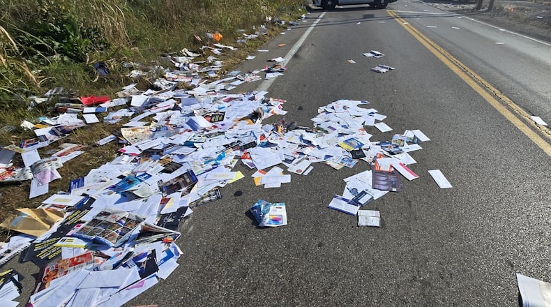Dayton police and the U.S. Postal Service are inspecting mail scattered along South Edwin C. Moses Boulevard on Wednesday, Oct. 30, 2024, to make sure it is only commercial mail, advertisements slated for recycling. CONTRIBUTED