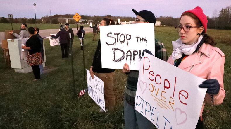 About 30 people gathered at the intersection of Enon Road and Speedway Drive in front of the Speedway headquarters in Enon to protest Speedway’s involvement in the Dakota Access Pipeline Wednesday evening. Bill Lackey/Staff