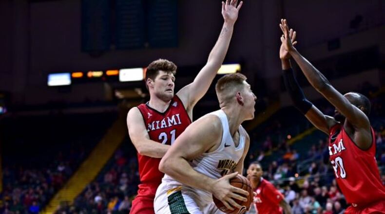 Wright State’s Loudon Love is defended by Miami’s Aleks Abrams (21) and Abdoulaye Harouna at the Nutter Center on Wednesday, Dec. 5, 2018. Joseph Craven/CONTRIBUTED